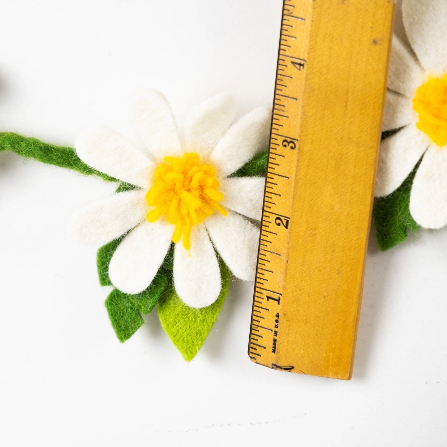 
                  
                    Winding Road Daisy Felt Garland with ruler
                  
                