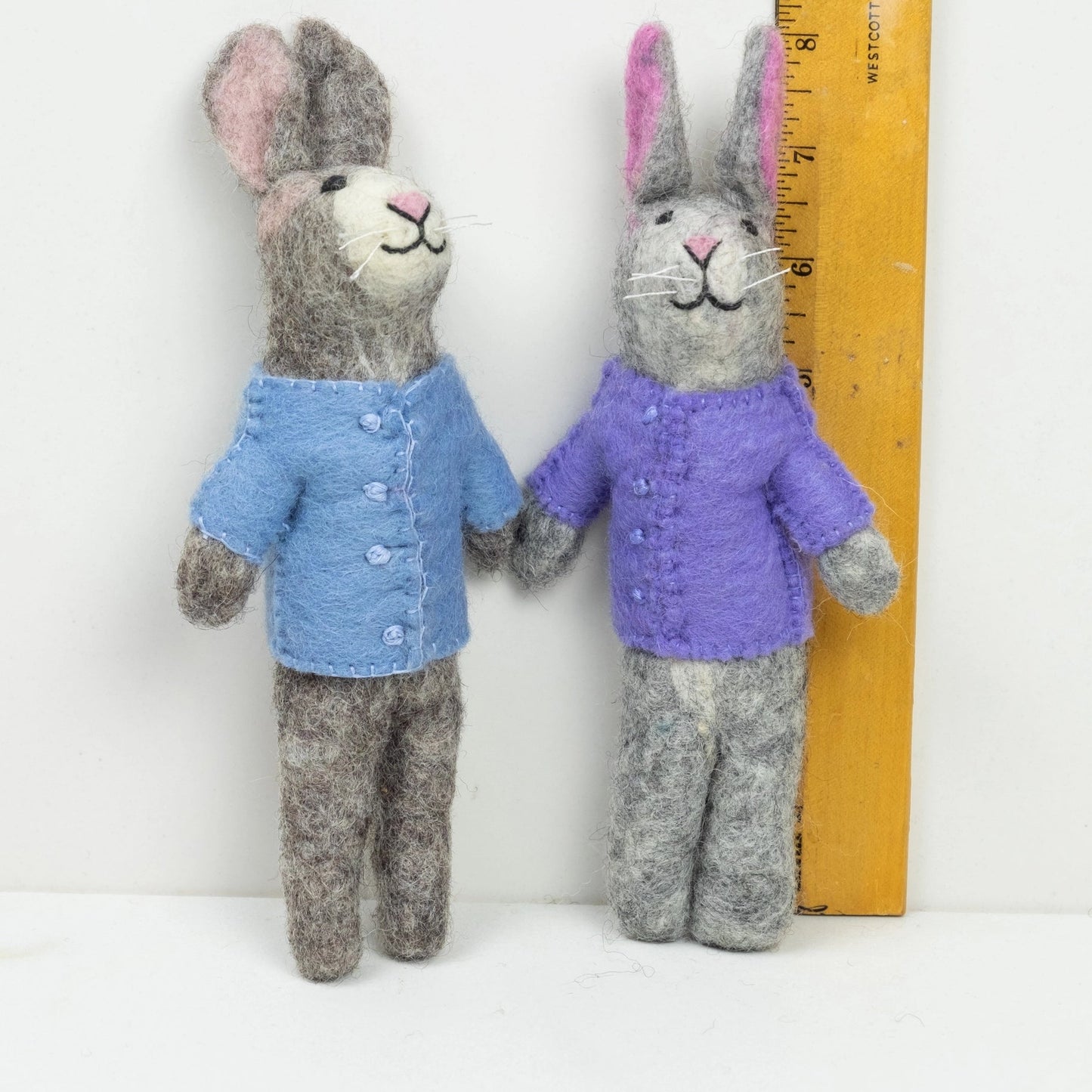 
                  
                    fair trade felt bunnies in blue and purple by a ruler the winding road
                  
                