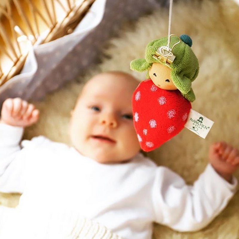 
                  
                    Nanchen strawberry rattle doll hung over baby
                  
                