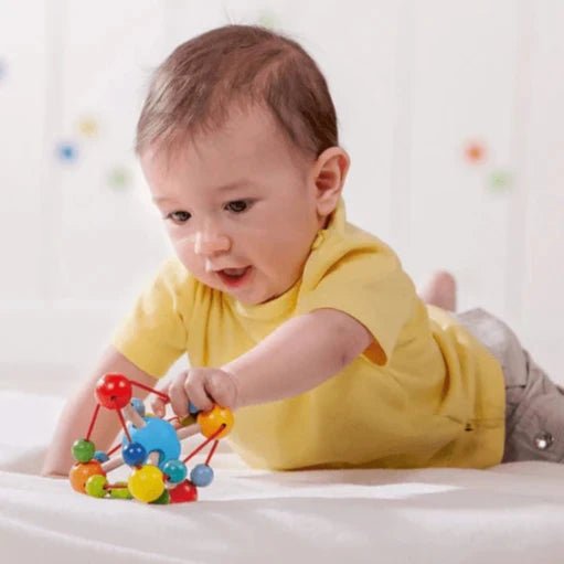 baby playing with haba tirili baby toy